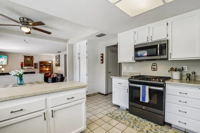 a living room with fireplace furniture and decor