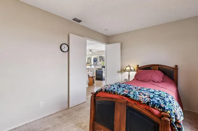 a bedroom with a bed and a dresser