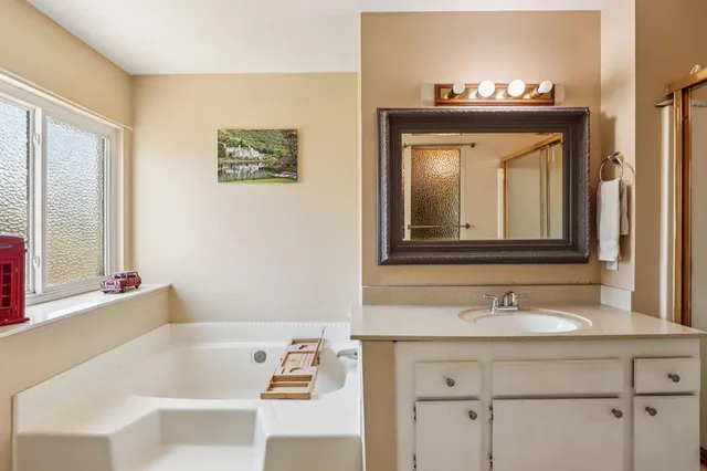 a en suite bathroom with a sink and a mirror