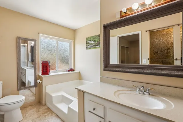 a bathroom with a double vanity sink mirror and shower