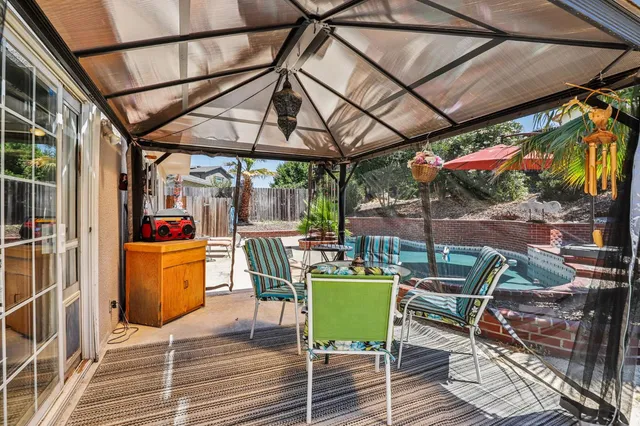 a view of a patio with swimming pool table and chairs