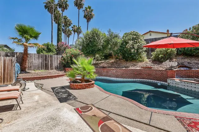 a view of a house with swimming pool and sitting area