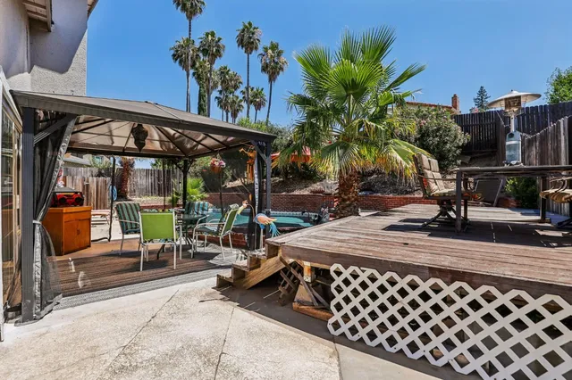 a view of a house with backyard sitting area and garden