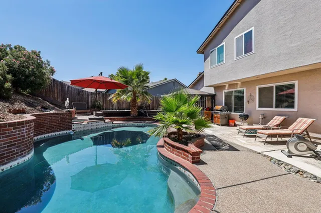 a view of an outdoor dining space with a table and chairs