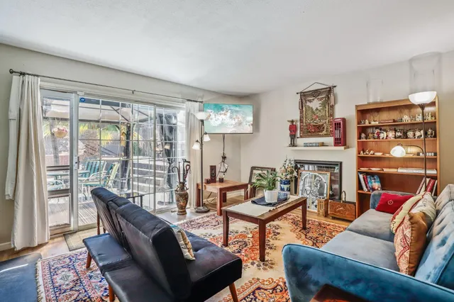 a living room with fireplace furniture and a large window
