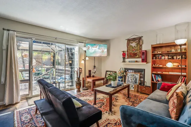 a living room with furniture and a floor to ceiling window