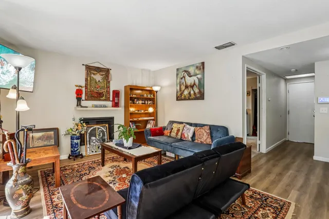 a living room with fireplace furniture and a window