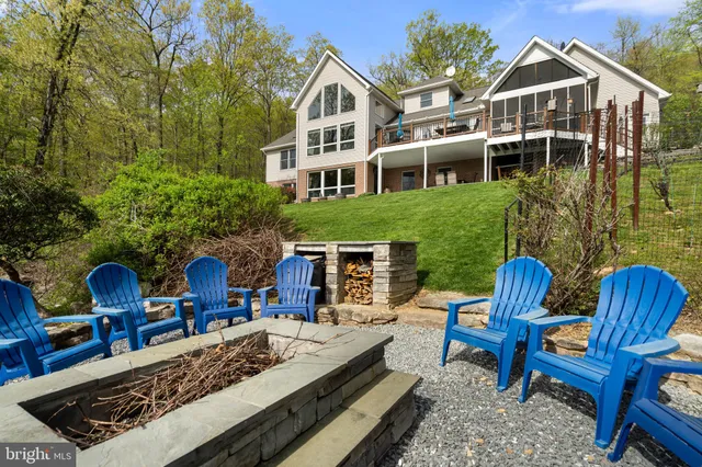 a dining room with furniture a chandelier and wooden floor