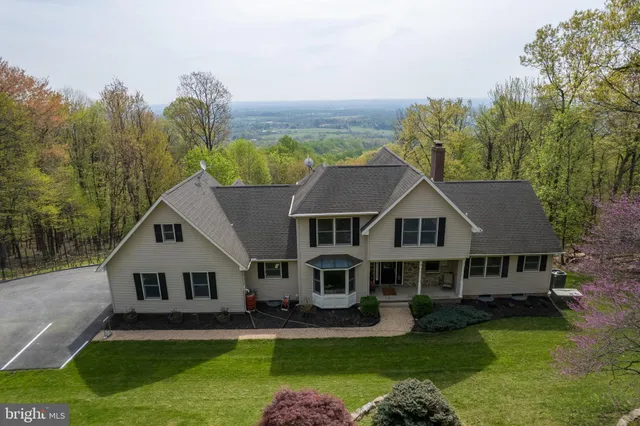 a kitchen with stainless steel appliances granite countertop a refrigerator a sink dishwasher a stove top oven a refrigerator with island and chairs