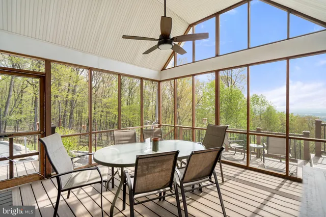 a bedroom with a bed and a large window with balcony view