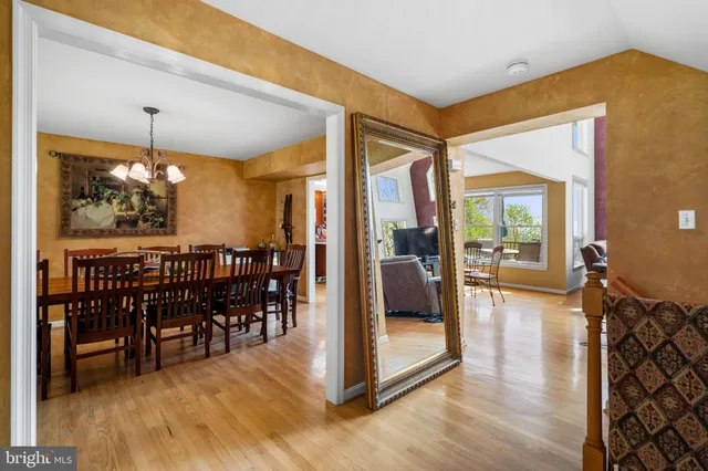 a living room with fireplace furniture and a large window