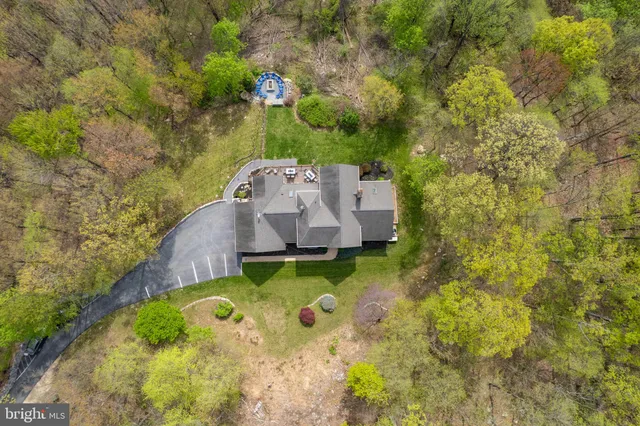 a backyard of a house with barbeque oven table and chairs