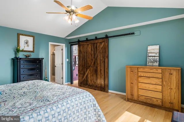 a front view of a dining room with furniture a chandelier and wooden floor