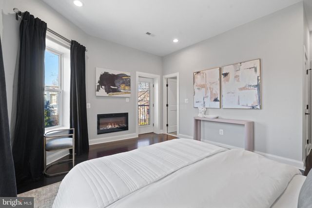 a bathroom with a double vanity sink toilet mirror and shower