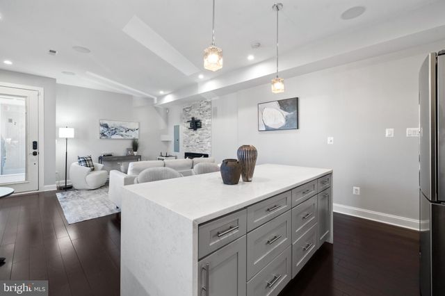 a kitchen with stainless steel appliances a stove microwave and refrigerator