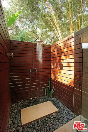 a view of a hallway with wooden floor and windows