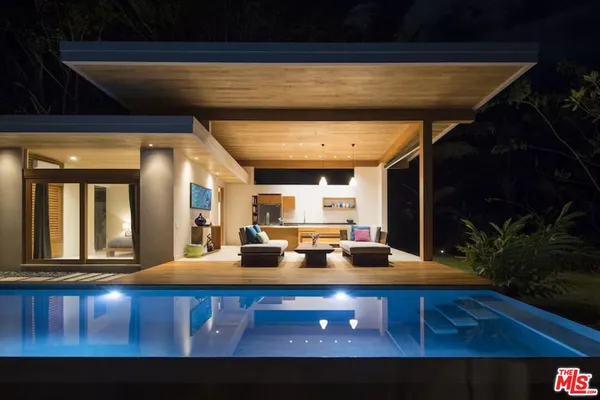 a view of a patio with swimming pool table and chairs