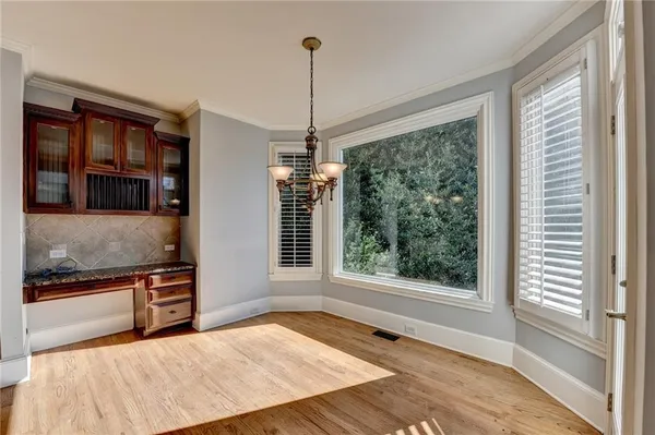 a view of a kitchen with a stove wooden floor and a kitchen