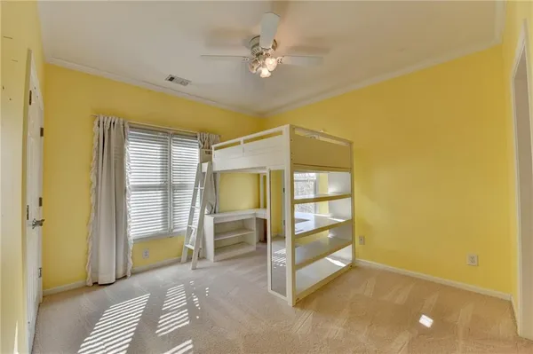 wooden floor in an empty room with a chandelier fan