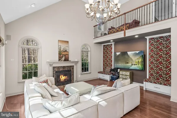 a living room with fireplace furniture and a chandelier