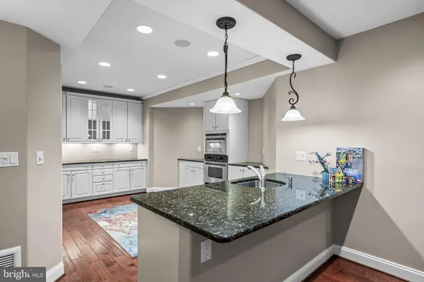 a kitchen with stainless steel appliances granite countertop a stove and cabinets