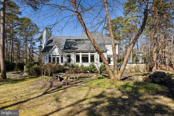 a view of swimming pool with lawn chairs yard