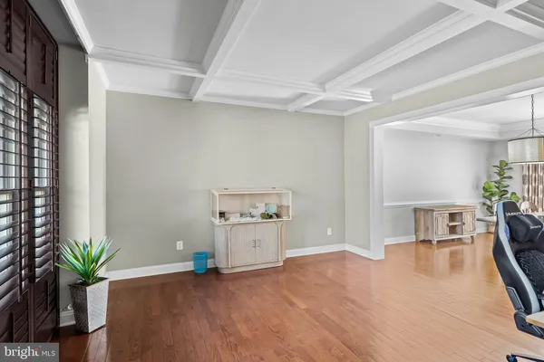 a dining room with furniture window and wooden floor