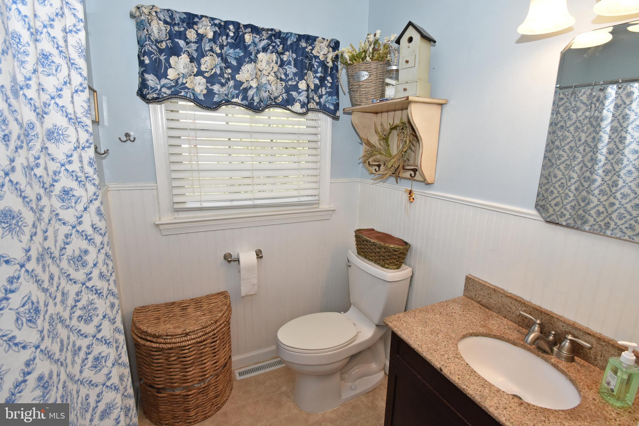30223 Mt Vernon Road Princess Anne, MD 21853 - Photo 20 of 53 a bathroom with a granite countertop sink and a mirror