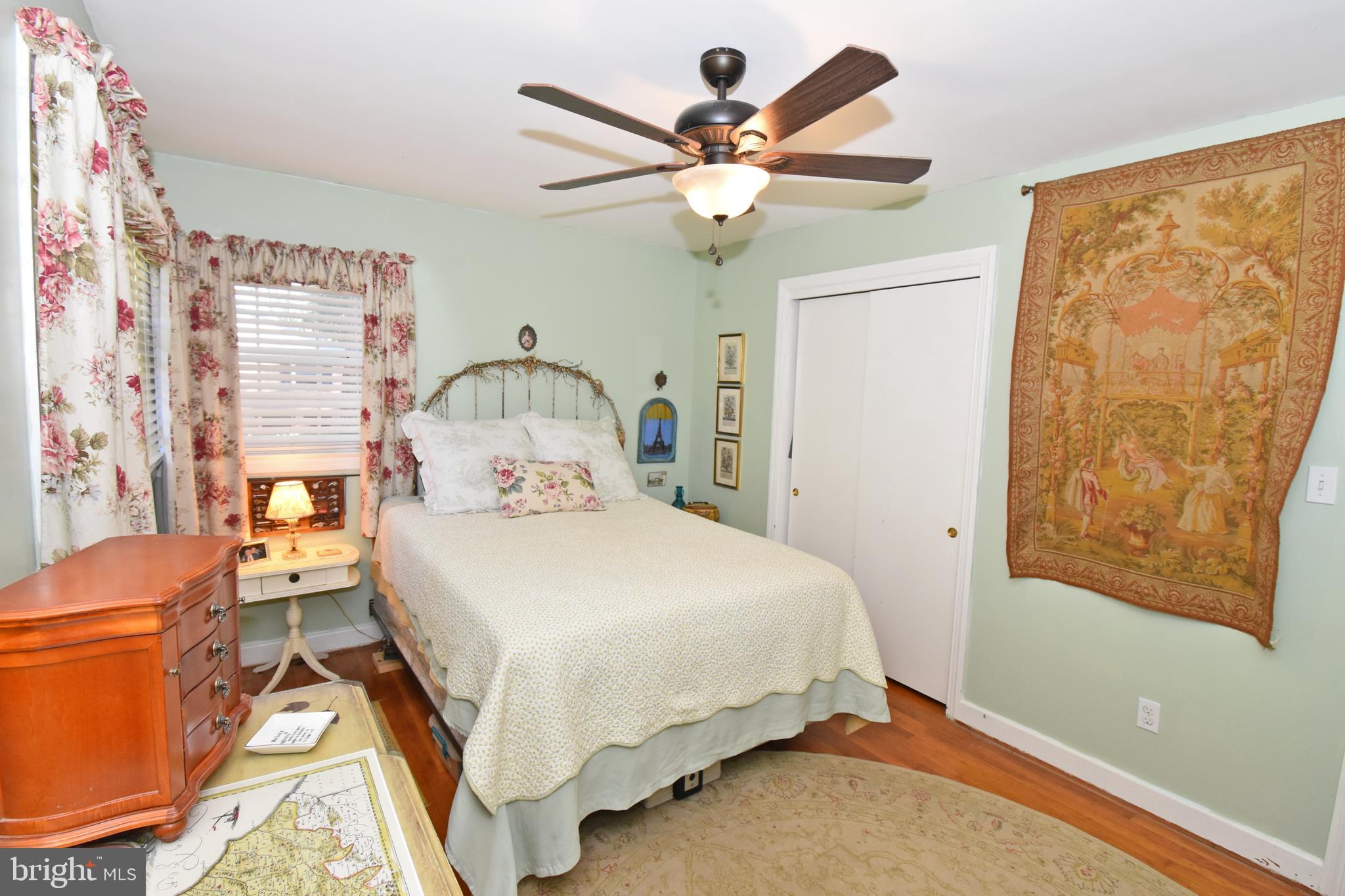 30223 Mt Vernon Road Princess Anne, MD 21853 - Photo 23 of 53 a bedroom with a bed and a chandelier