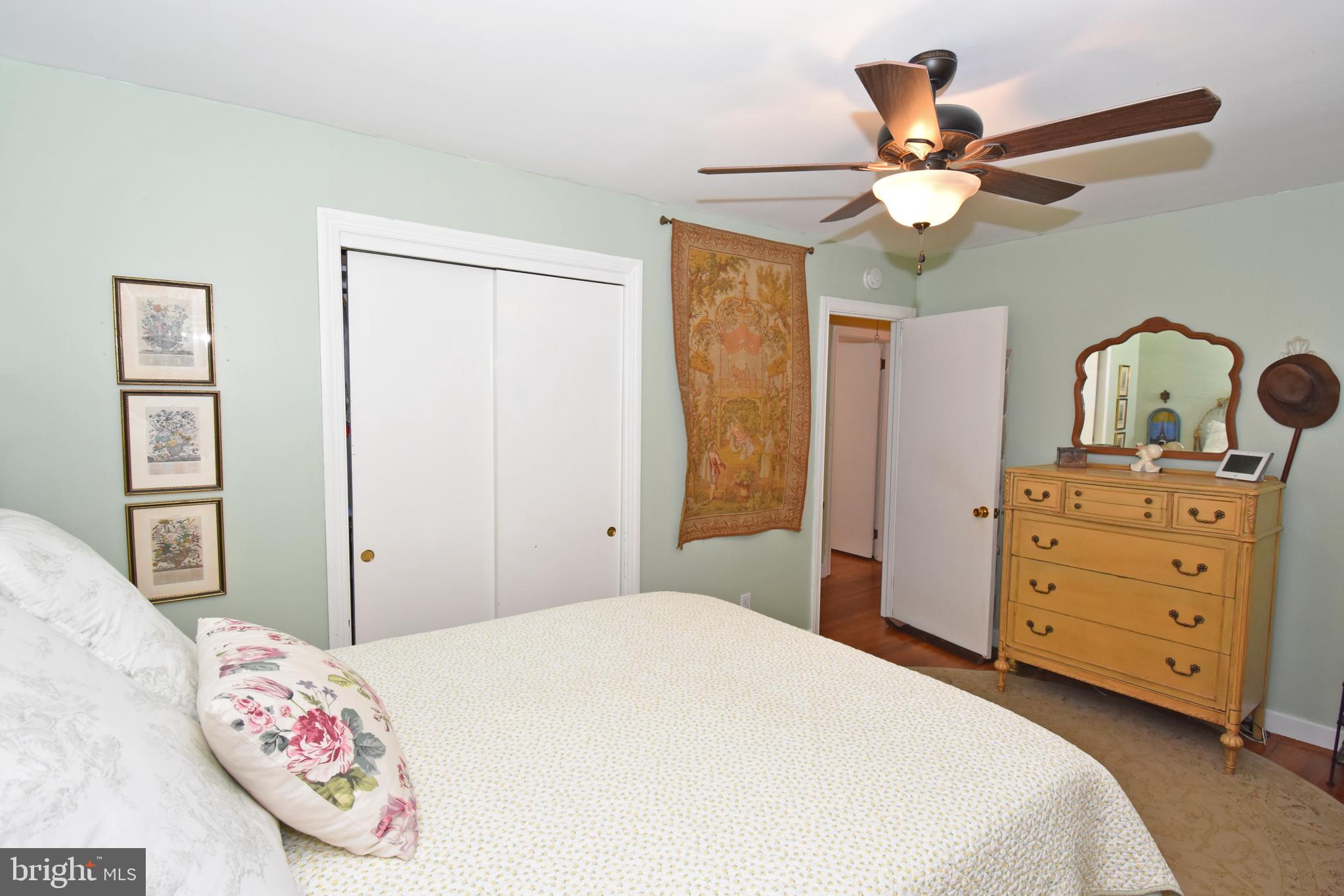 30223 Mt Vernon Road Princess Anne, MD 21853 - Photo 24 of 53 a bedroom with a bed and a chandelier