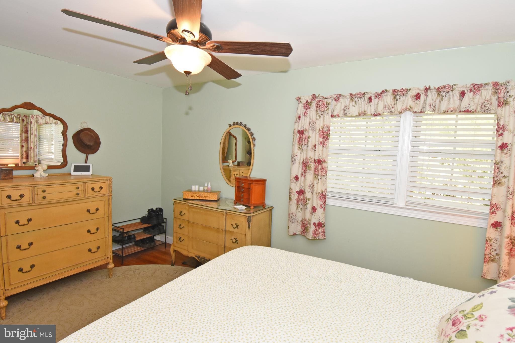 30223 Mt Vernon Road Princess Anne, MD 21853 - Photo 25 of 53 a bedroom with a bed and a chandelier