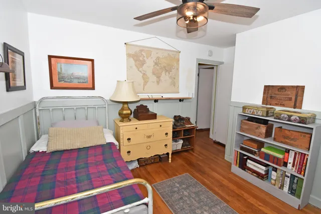 a living room with furniture and a book shelf