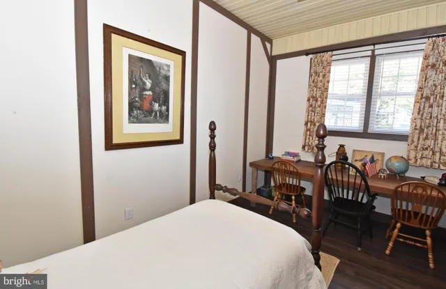 a bedroom with a bed and a table with chair