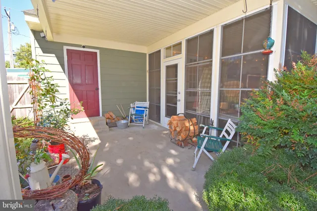 a view of a chairs and table in backyard of the house