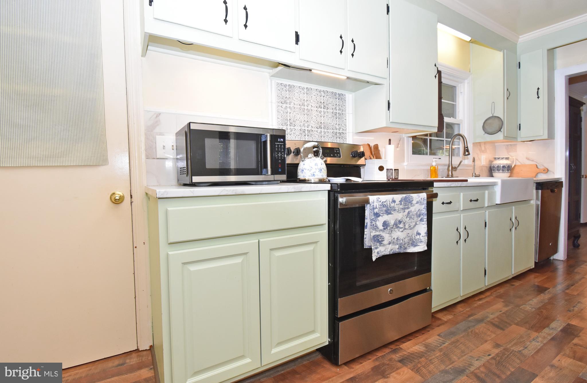 30223 Mt Vernon Road Princess Anne, MD 21853 - Photo 7 of 53 a kitchen with stainless steel appliances granite countertop a stove a sink and a microwave