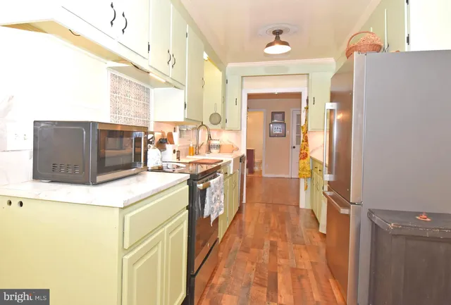 a kitchen with a sink and a refrigerator