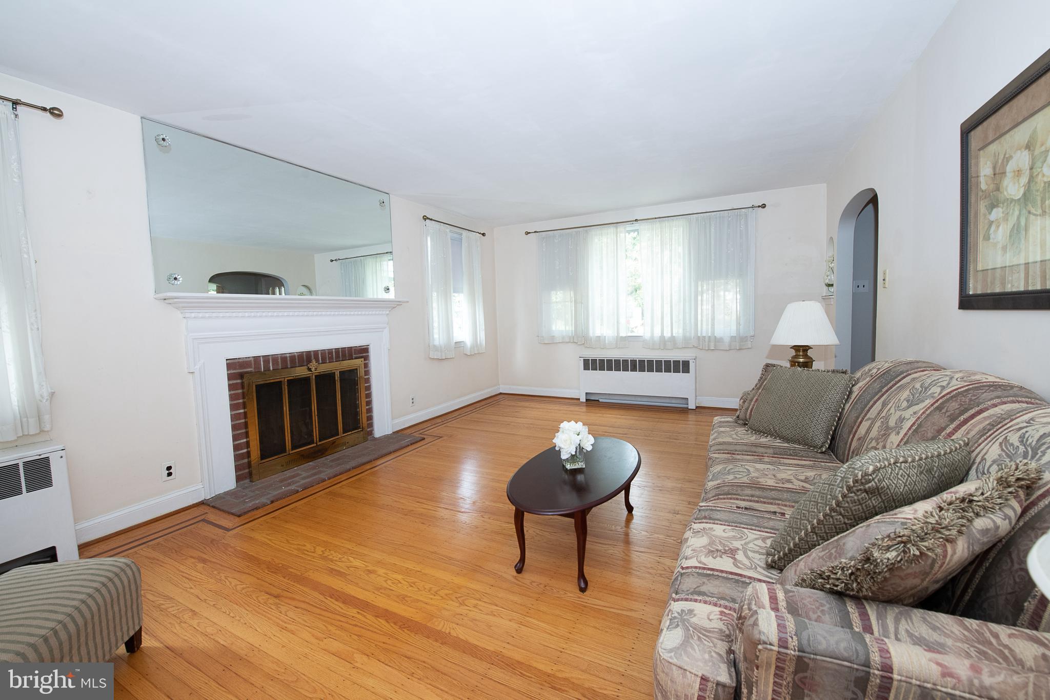 1454 Manoa Road Wynnewood, PA 19096 - Photo 16 of 41 a living room with furniture a fireplace and a large window