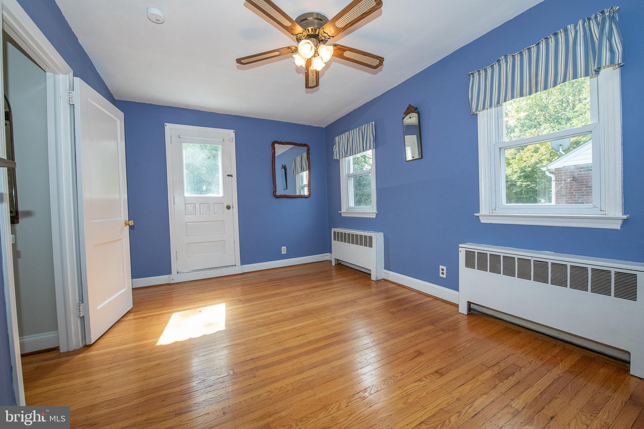 1454 Manoa Road Wynnewood, PA 19096 - Photo 21 of 41 a view of an empty room with window and wooden floor