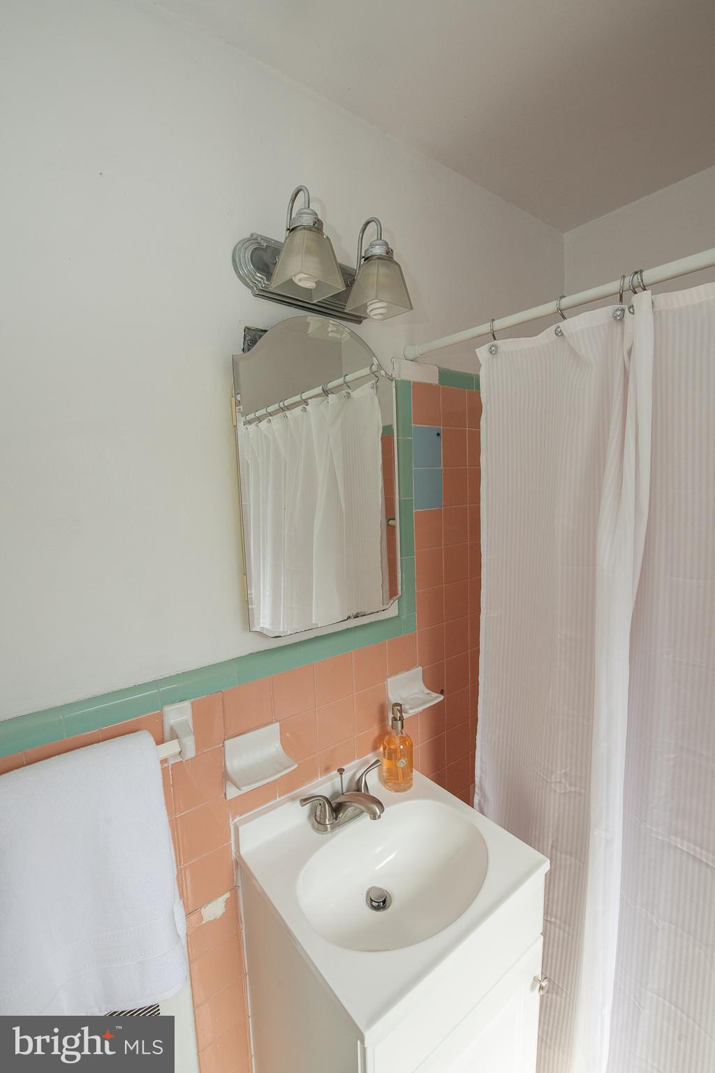 1454 Manoa Road Wynnewood, PA 19096 - Photo 23 of 41 a bathroom with a sink and a mirror