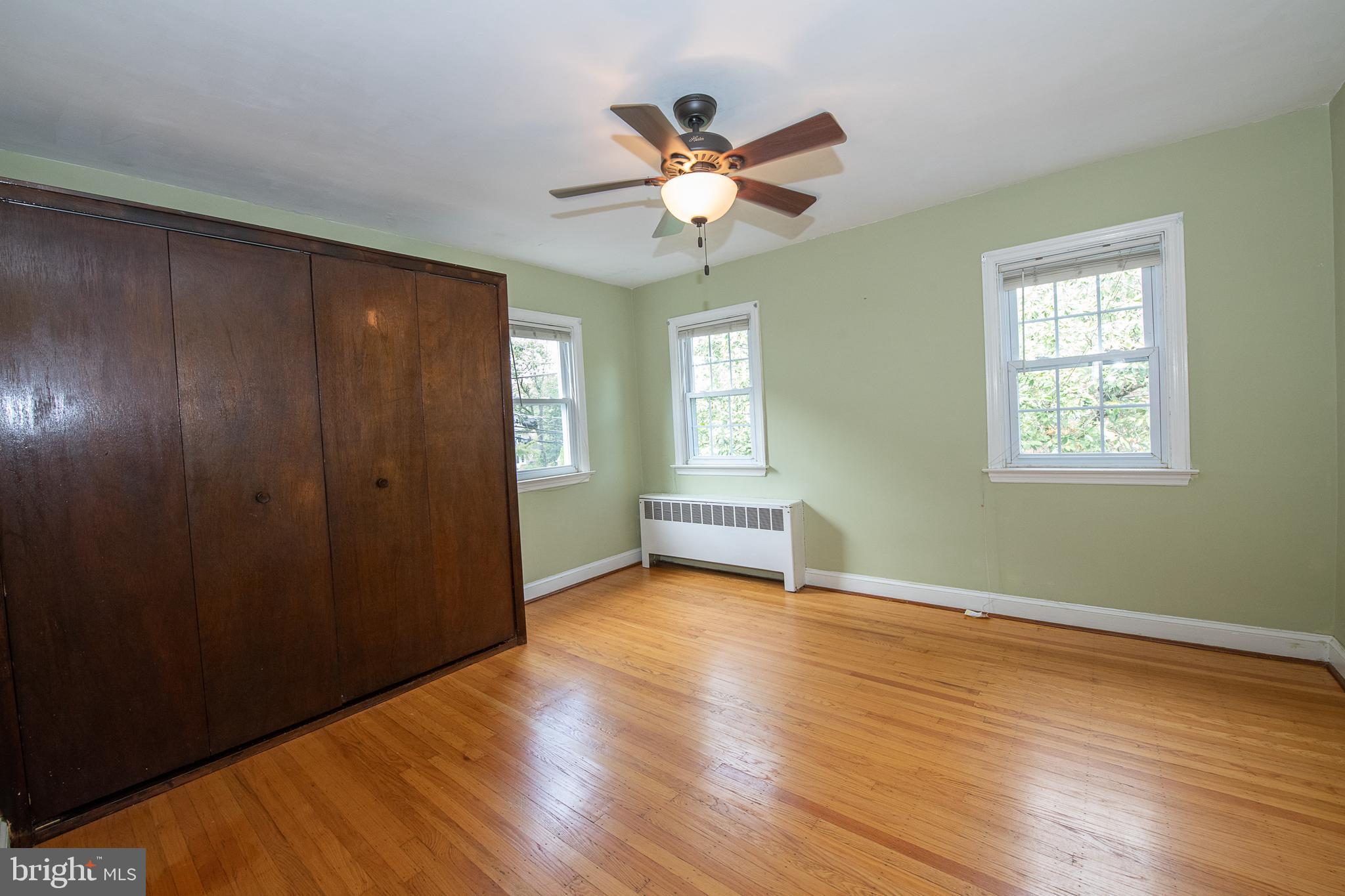 1454 Manoa Road Wynnewood, PA 19096 - Photo 24 of 41 a view of an empty room with a window and wooden floor