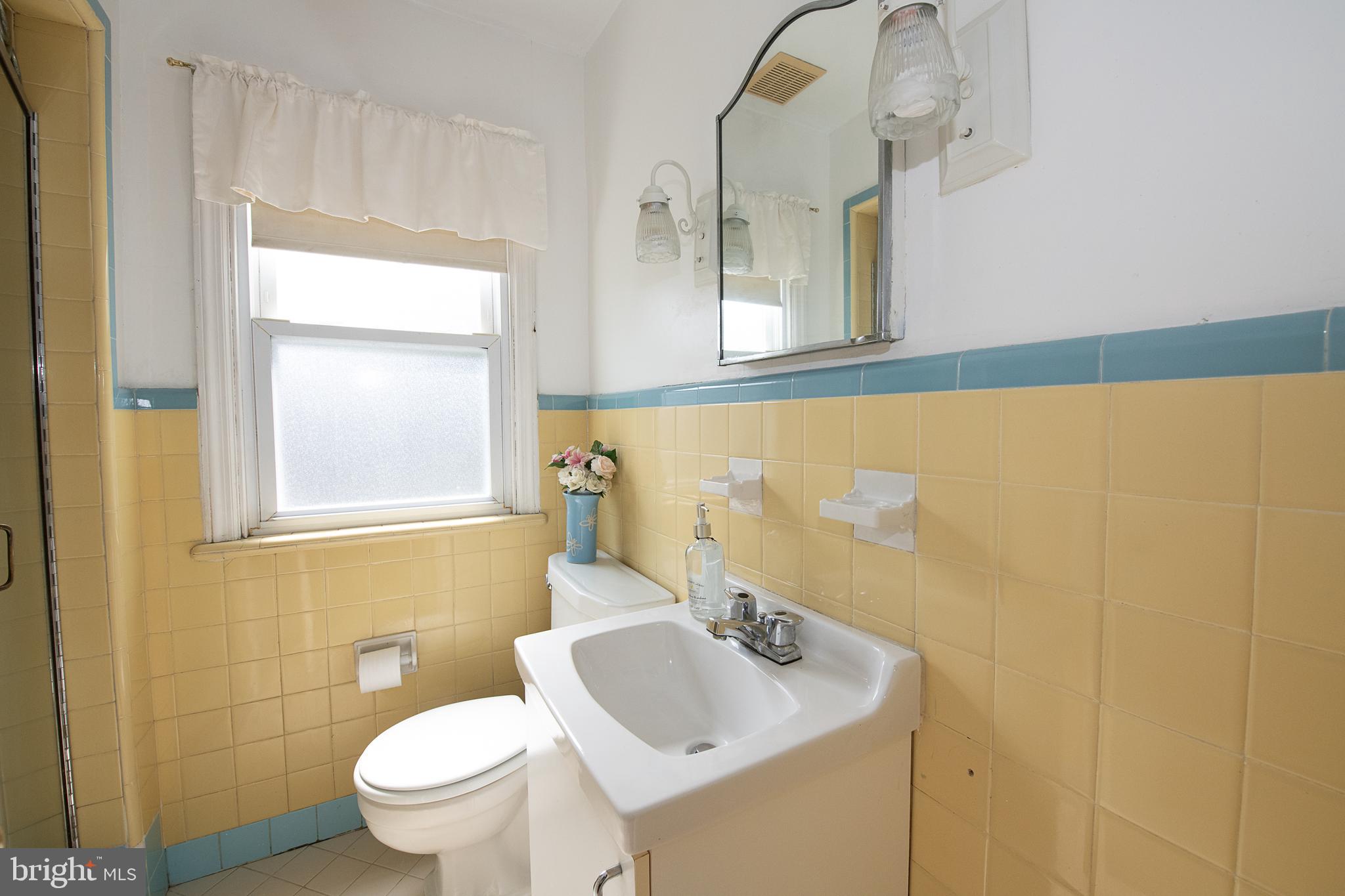 1454 Manoa Road Wynnewood, PA 19096 - Photo 28 of 41 a bathroom with a sink a toilet and mirror