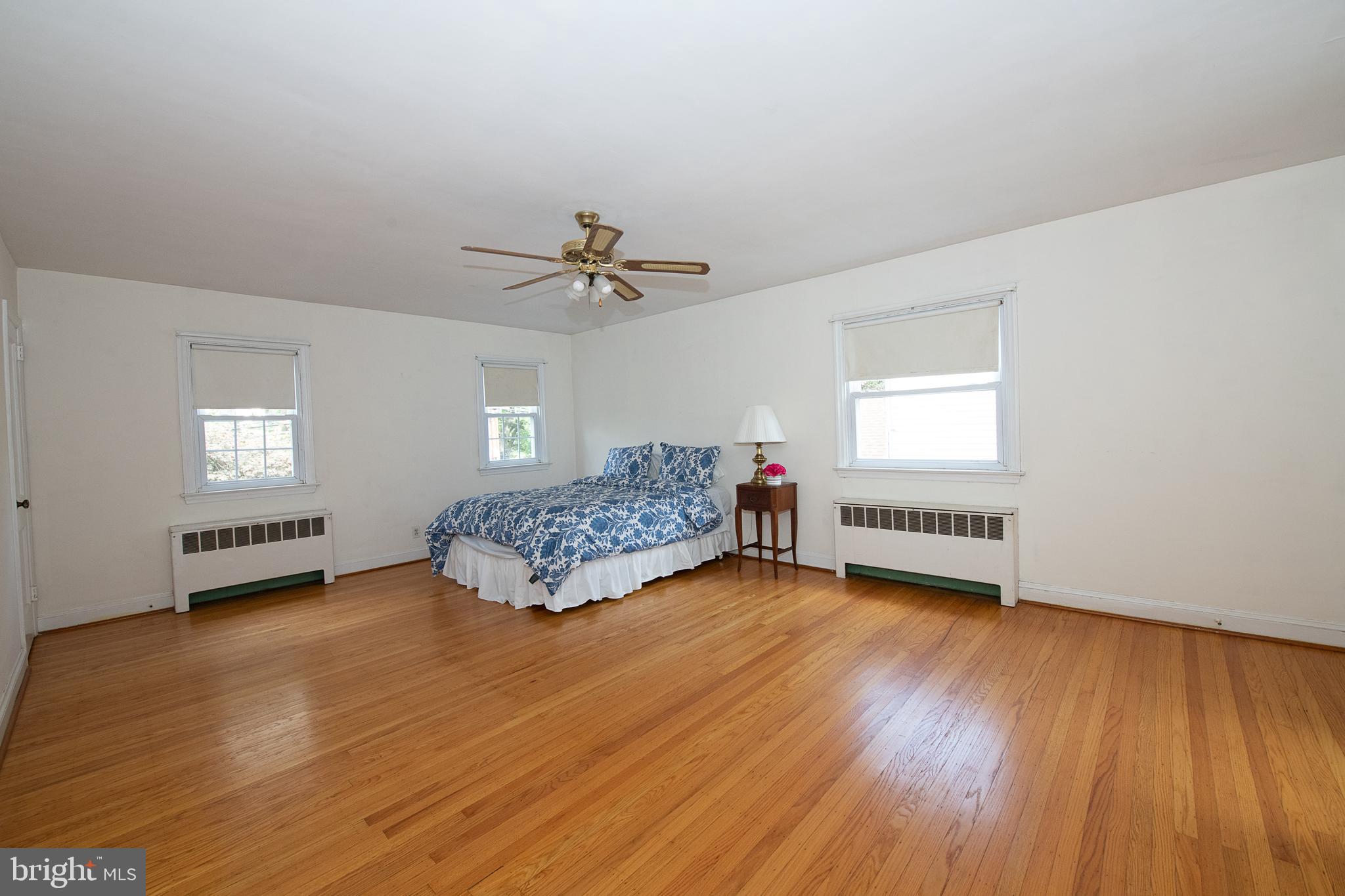 1454 Manoa Road Wynnewood, PA 19096 - Photo 30 of 41 a spacious bedroom with a bed a dresser and wooden floor