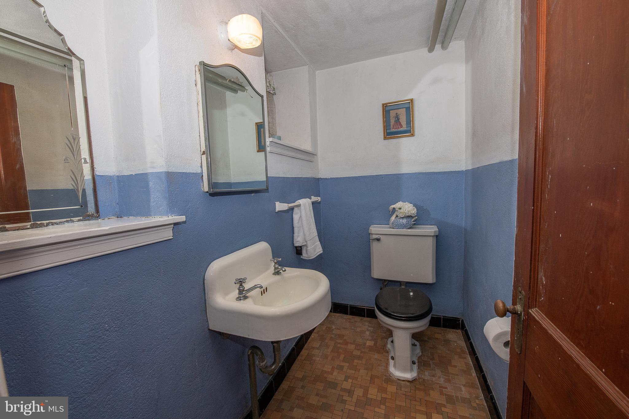 1454 Manoa Road Wynnewood, PA 19096 - Photo 34 of 41 a bathroom with a toilet sink and mirror