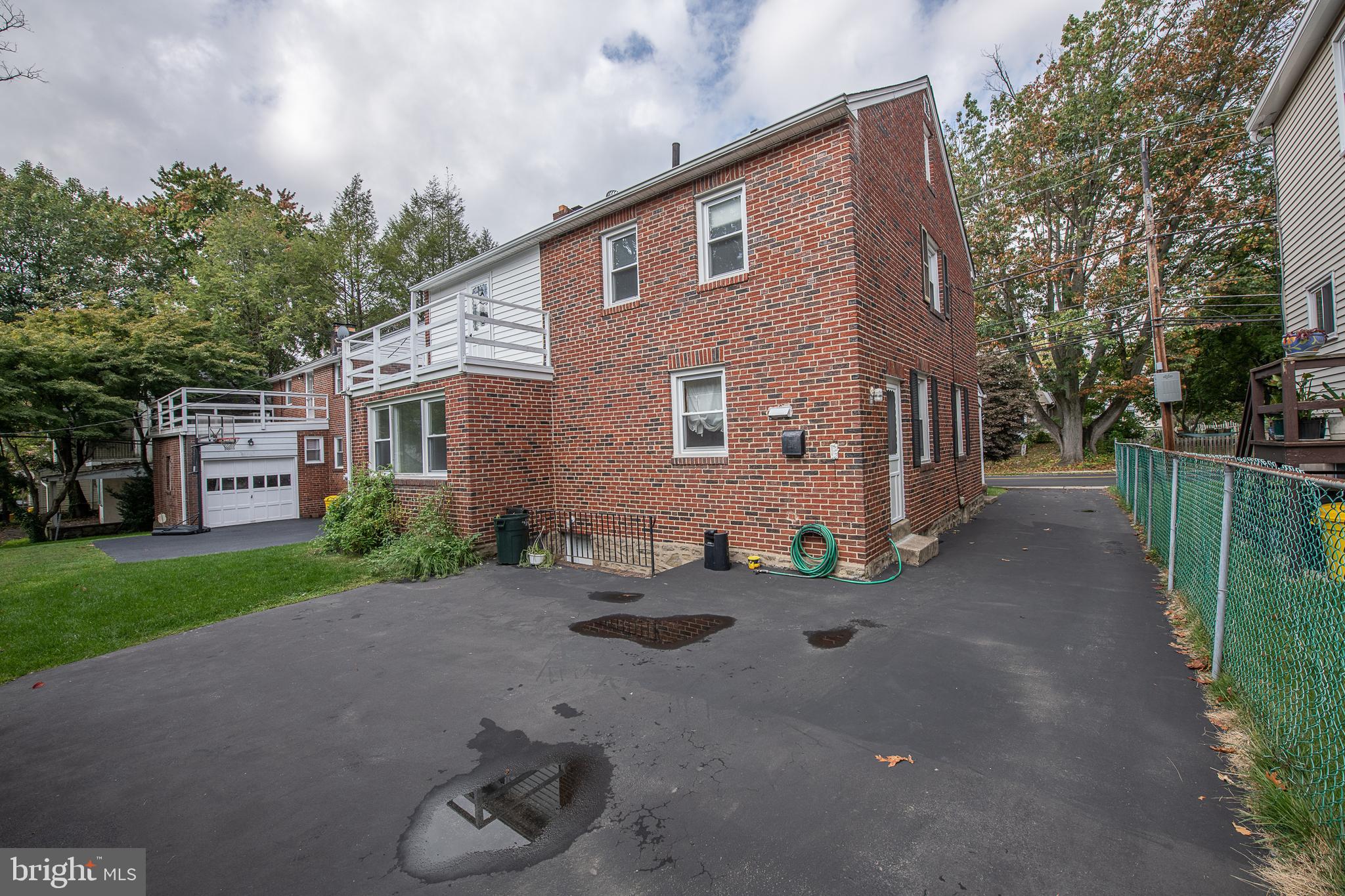 1454 Manoa Road Wynnewood, PA 19096 - Photo 37 of 41 a front view of a house with a yard