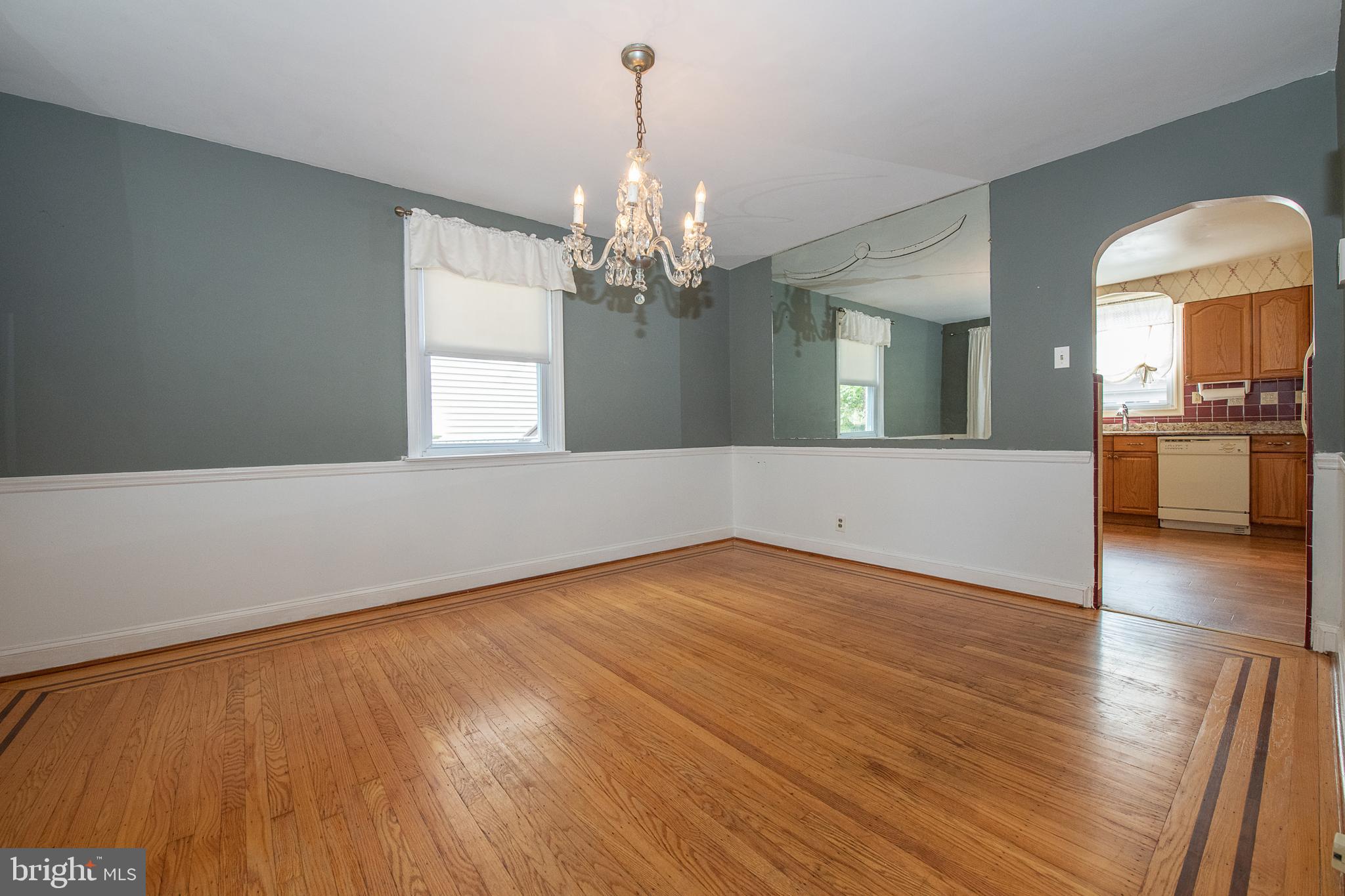 1454 Manoa Road Wynnewood, PA 19096 - Photo 8 of 41 a view of a room with wooden floor and chandelier