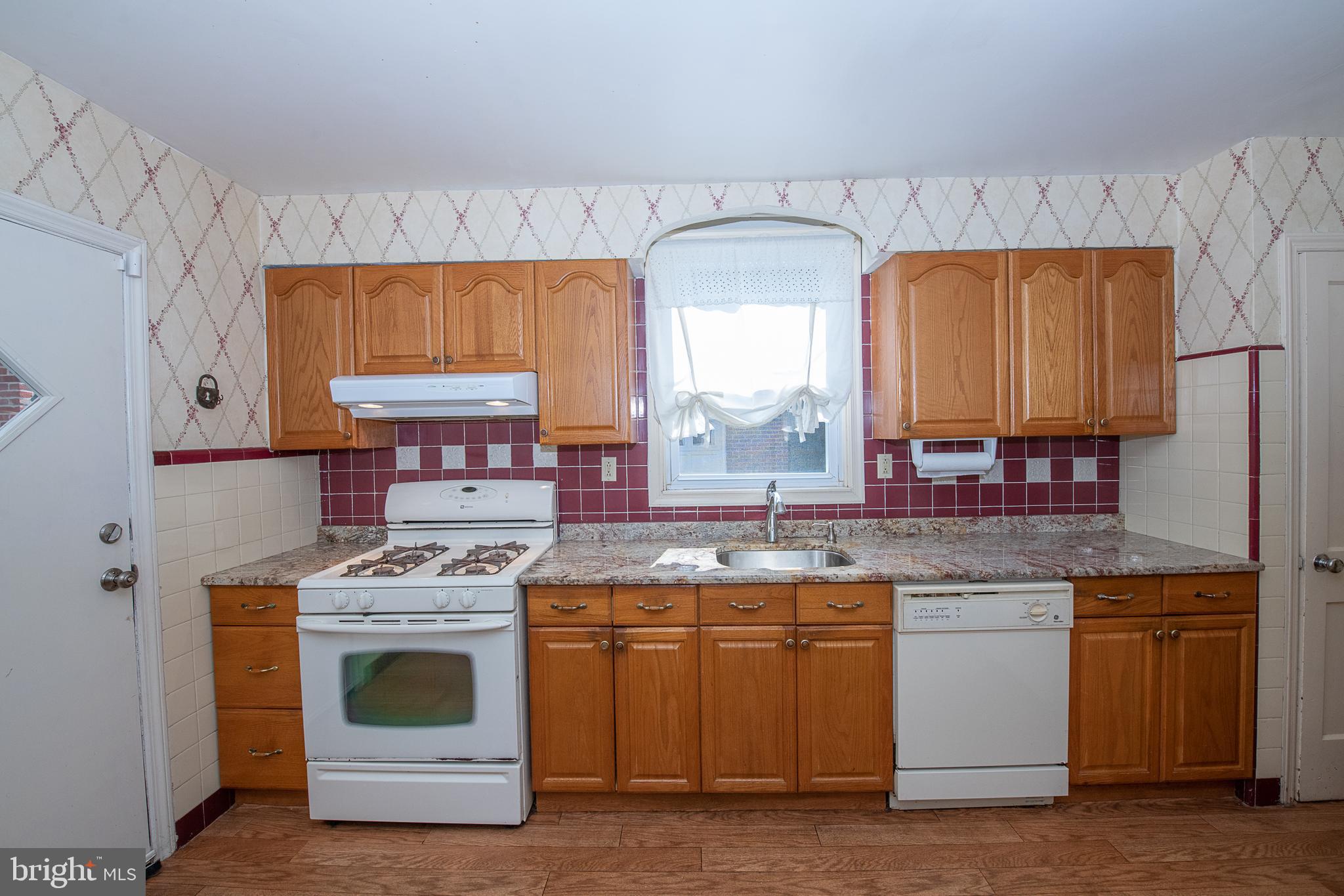 1454 Manoa Road Wynnewood, PA 19096 - Photo 10 of 41 a kitchen with a stove sink and cabinets