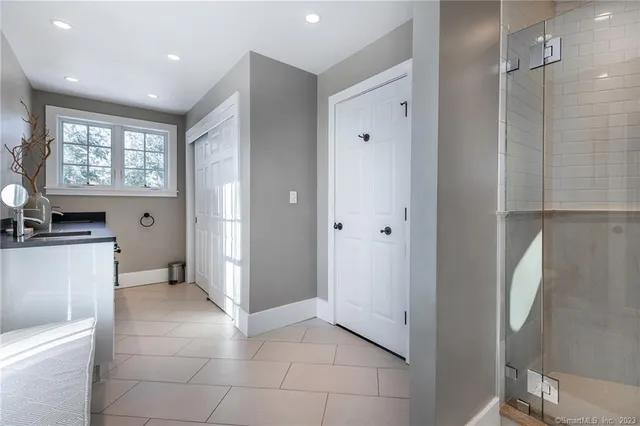 a spacious bedroom with a bed and a couch