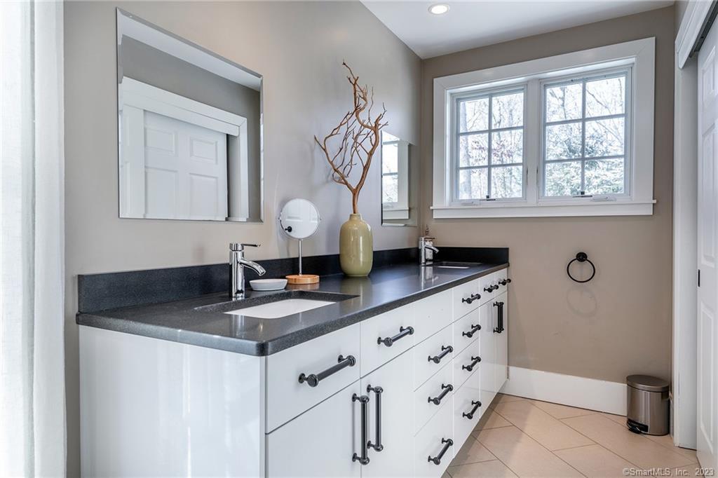 104 Lower Church Hill Road Washington, CT 06794 - Photo 16 of 23 a bathroom with a granite countertop sink a mirror and a window