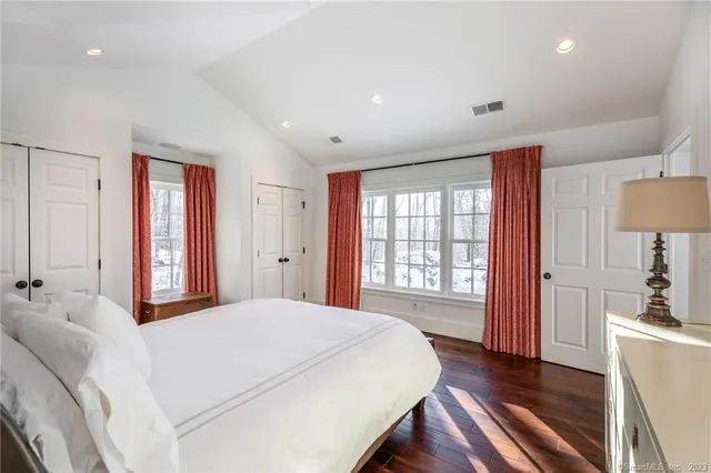 a bathroom with a granite countertop sink a mirror and a window
