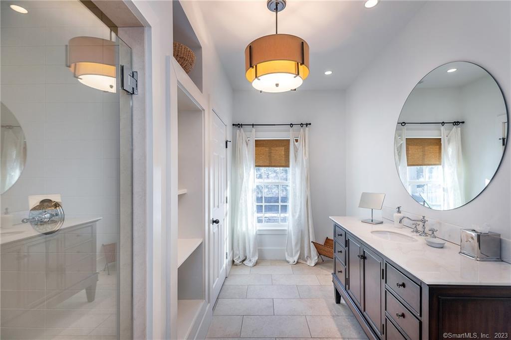 104 Lower Church Hill Road Washington, CT 06794 - Photo 18 of 23 a spacious bathroom with a double vanity sink and a mirror